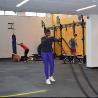 <p>Faton Niang of New Canaan works out with the ropes at the renovated fitness area at the New Canaan YMCA.</p>