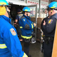 <p>Emergency responders at the scene of the roof collapse at National Wholesale Liquidators on Central Avenue.</p>