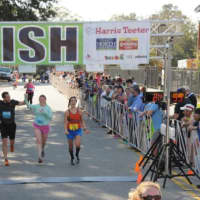 <p>Ryan Fox of Danbury, right, crosses the finish line at the Charleston Marathon in South Carolina, where he finished second.</p>