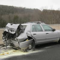 <p>A motorist allegedly slammed into a parked State Police vehicle on Route 7 in Brookfield Monday morning. The driver and trooper were taken to hospital with undetermined injuries.</p>