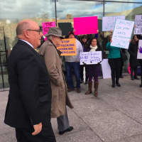<p>Greenwich RTM member Chris Von Keyserling, in hat, walking with lawyer Phil Russell past protestors following his first court appearance on a sexual assault charge.</p>