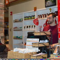 <p>A customer is served at the Easton Village Store</p>
