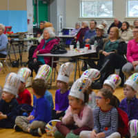 <p>Members of the Bigelow Center for Senior Activities and kindergarteners for Osborn Hill Elementary School listen to the school&#x27;s fifth-grade chorus.</p>