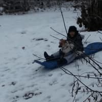 <p>Hannah McGuire playing in the snow with her dog Lyric</p>