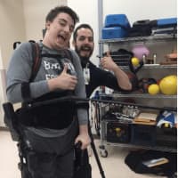 <p>Zach with his physical therapist, Tim</p>