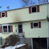 <p>Fire damage can be seen at 14 Kettle Road in Norwalk. Officials are trying to determine how the blaze began.</p>