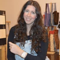 <p>Meagan Cann shows a lily bracelet, made from a bull&#x27;s horn and sisal grass in an artisan workshop in Rwanda.</p>