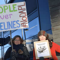 <p>Protesters who oppose the construction of the Dakota Access Pipeline march in Stamford on Friday afternoon.</p>
