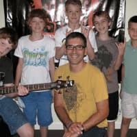 <p>David Morgan (front and center), owner and founder of the Music Shed in Redding, surrounded by his students</p>