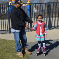<p>7-year-old Ashlee Evans with her father Rodney Evans, enjoying the summer-like weather Friday afternoon at Rogers Park in Danbury</p>