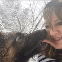 <p>Danbury resident Kristin Wolfe plays in the snow with her 7-year-old German shepherd, Zara.</p>