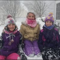 <p>From left, Marianna, Haley and Corinne play in the snow in Danbury. They all had a sleepover last night since school was canceled for the day.</p>