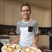<p>13-year-old Ryan Wunsch of Danbury is making pancakes Tuesday.</p>