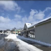 <p>Scott Clifford of Danbury plows the area outside of Peachwave in Brookfield, which is owned by his family.</p>