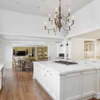 <p>The kitchen has white cabinets and hardwood floors.</p>
