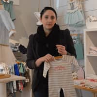 <p>Darcy Callahan, manager at Pink Lemon, Blue Lime in Westport, shows some of the store&#x27;s fashions.</p>