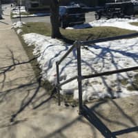 <p>The pedestrian bridge with the adjacent fire department station parking lot in the background where a man swung a knife at a 24-year-old woman Tuesday evening. She was uninjured and the man was arrested.</p>