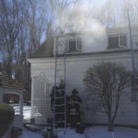 <p>Greenwich firefighters at the scene of a fire at a Buckfield Lane home Thursday.</p>