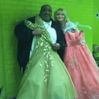 <p>Clyde Thompson and Anne Tack show off some of the donated prom dresses from The Cinderella Project.</p>