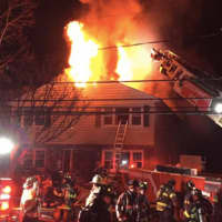 <p>A photo of flames leaping out of 63 Riverdale Ave., Friday morning.</p>