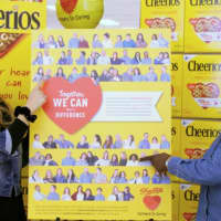 <p>Croton ShopRite associates Sandra Puglielle, left, of Newburgh and Nora Bellamy of the Bronx point to their pictures on the special-edition Cheerios box featured now in ShopRite stores.</p>