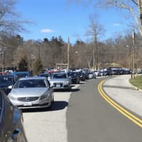 <p>Motorists double parked outside Greenwich High School as they wait for a lockdown to end. Police said they are investigating a noontime threat at the school.</p>