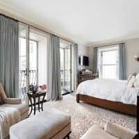 <p>The bedroom features floor to ceiling windows that open onto a French balcony.</p>