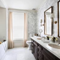 <p>The master bathroom contains a mosaic floor and spa-like luxury.</p>