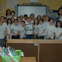 <p>Concord Road Elementary School in Ardsley, where second-grader Andrew Wenzel shows off his certificate with classmates.</p>