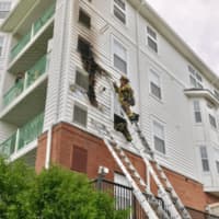 <p>Stamford firefighters quickly extinguish a fast-moving two-alarm fire Thursday at 150 Southfield Ave.</p>