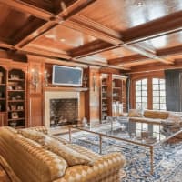 <p>The wood-paneled living room and library at 9 Terrace Circle in Armonk combines elegance and comfort.</p>