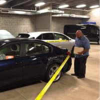 <p>A Greenwich police investigator checks out a recovered stolen car.</p>