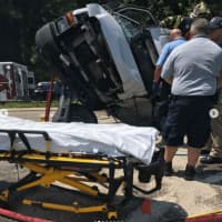 <p>EMS and fire officials work to remove a person entrapped in a van following a crash.</p>