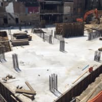 <p>Contracting crews spent hours pouring the foundation at 587 Main St. in New Rochelle.</p>