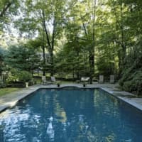 <p>Hidden from view and surrounded by expertly arranged landscaping is an inground pool, providing the perfect private retreat for cooling off.</p>