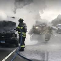 <p>Fire crews tackled a burning engine in a cargo van during Monday morning rush hour on the Merritt Parkway in Fairfield.</p>