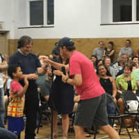 <p>U.S. Sen. Chris Murphy goes to high-five Kenneth Miller after the 6-year-old asked a question at a meeting last August at Edmond Town Hall in Newtown.</p>