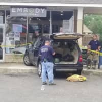 <p>A car crashes into Embody Fitness Gourmet in Darien on Thursday.</p>