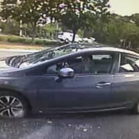 <p>The suspect in a Monroe bank robbery fled in this newer model gray Honda Civic.</p>