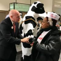 <p>Franchise owner Archer Bullock welcomes one of the first customers early Thursday at the new Chick-Fil-A in Norwalk.</p>