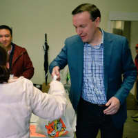 <p>U.S. Sen. Chris Murphy distributes bags of food for Thanksgiving at Person-To-Person in Norwalk on Wednesday.</p>
