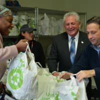 <p>Norwalk Mayor Harry Rilling, center, and state Sen. Bob Duff distributed bags filled with food for Thanksgiving at Person-To-Person in Norwalk on Wednesday.</p>