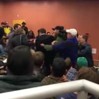 <p>A brawl breaks out at as Lucian Wintrich, White House correspondent for The Gateway Pundit, grabs a female student to retrieve a paper she took from his podium during a speech at UConn.</p>