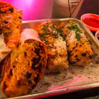 <p>Pollo Tinga Mission Style burrito with Mexican Street Corn at Eat Tacoria in Montclair.</p>
