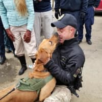 <p>Trooper First Class Ed Anuszewski greets his K9 partner Texas, who was missing for 36 hours.</p>