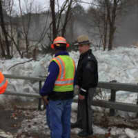 <p>State police and state DOT workers work to clear the ice chunks along Route 209.</p>