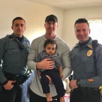 <p>Officers Brad Gilmoure and Kenneth Knebl and Sgt. Justin Tress met baby Lyon Judah Garcia at his home on Sunday.</p>