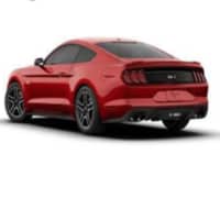 <p>A red Ford Mustang sedan.</p>