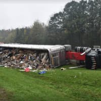 <p>A tractor-trailer flipped on its side after clipping another vehicle.</p>