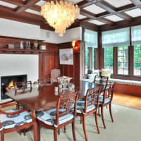 <p>Exposed wood beams and a fireplace complement the dining room&#x27;s views.</p>